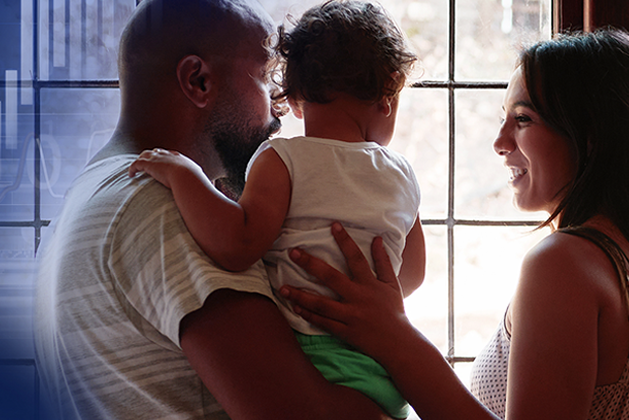 Young family looking out a window in their home